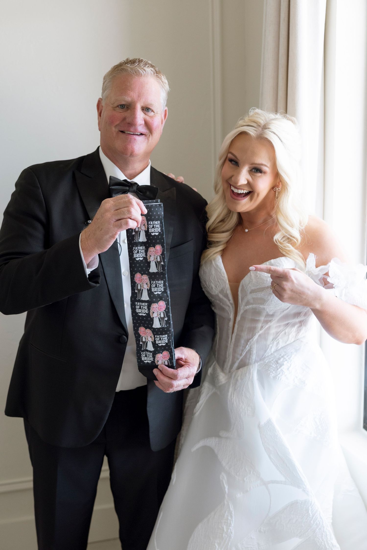 Joyful wedding celebration moment with laughter and drinks being shared in an elegant indoor setting.