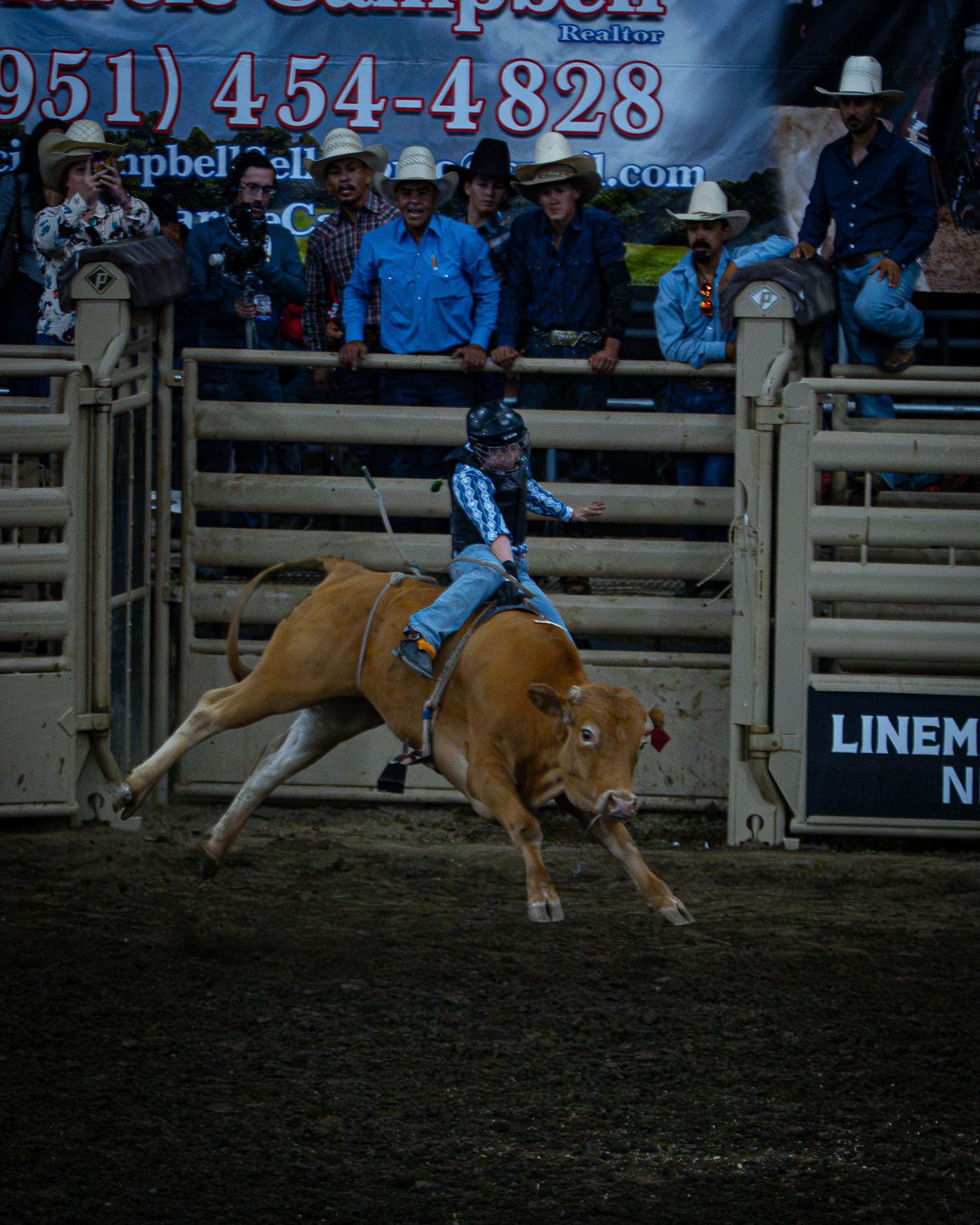 Rodeo rider competing on horseback inside a Western arena