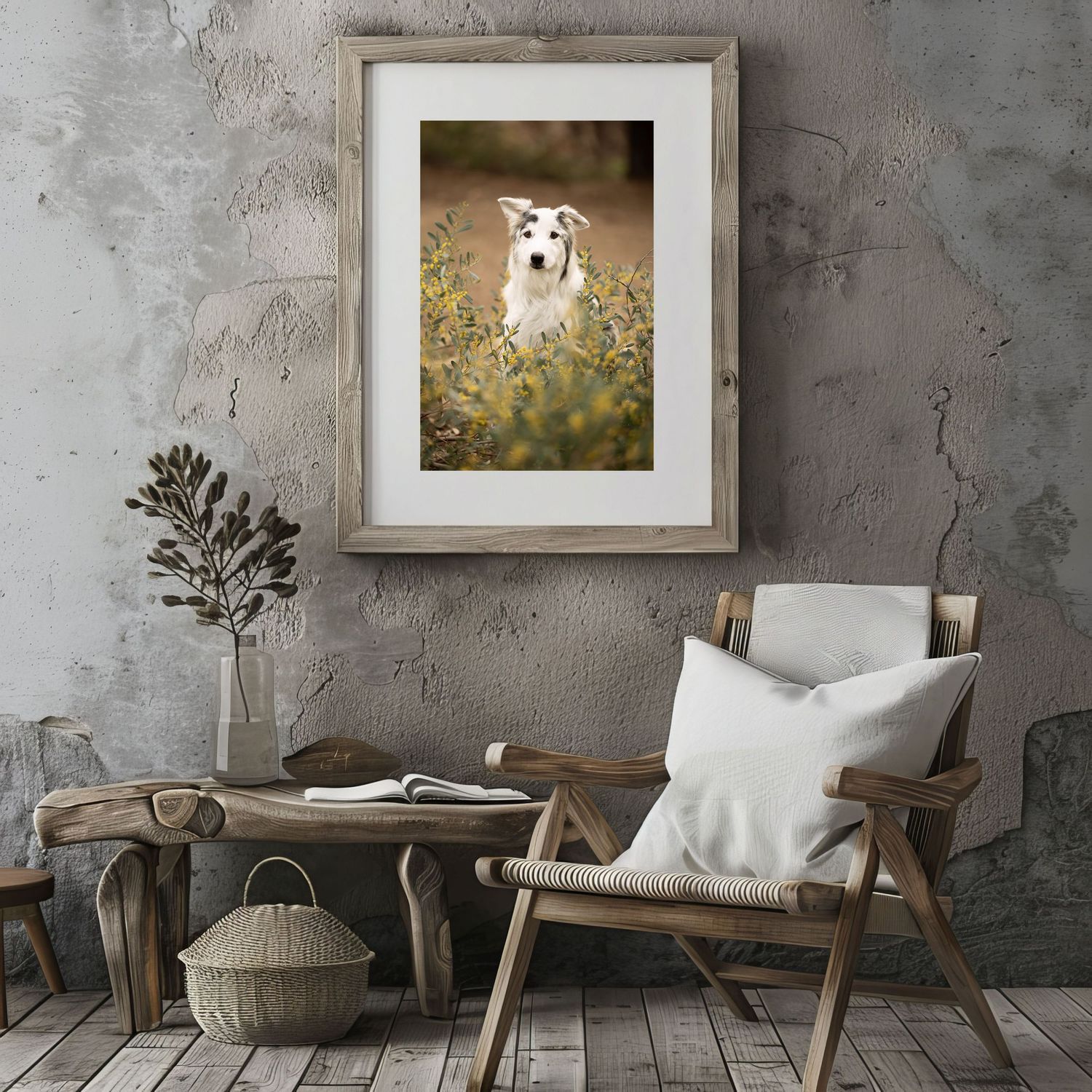 Framed photo of a white dog in a meadow, displayed above rustic wooden furniture in a cozy gray interior.