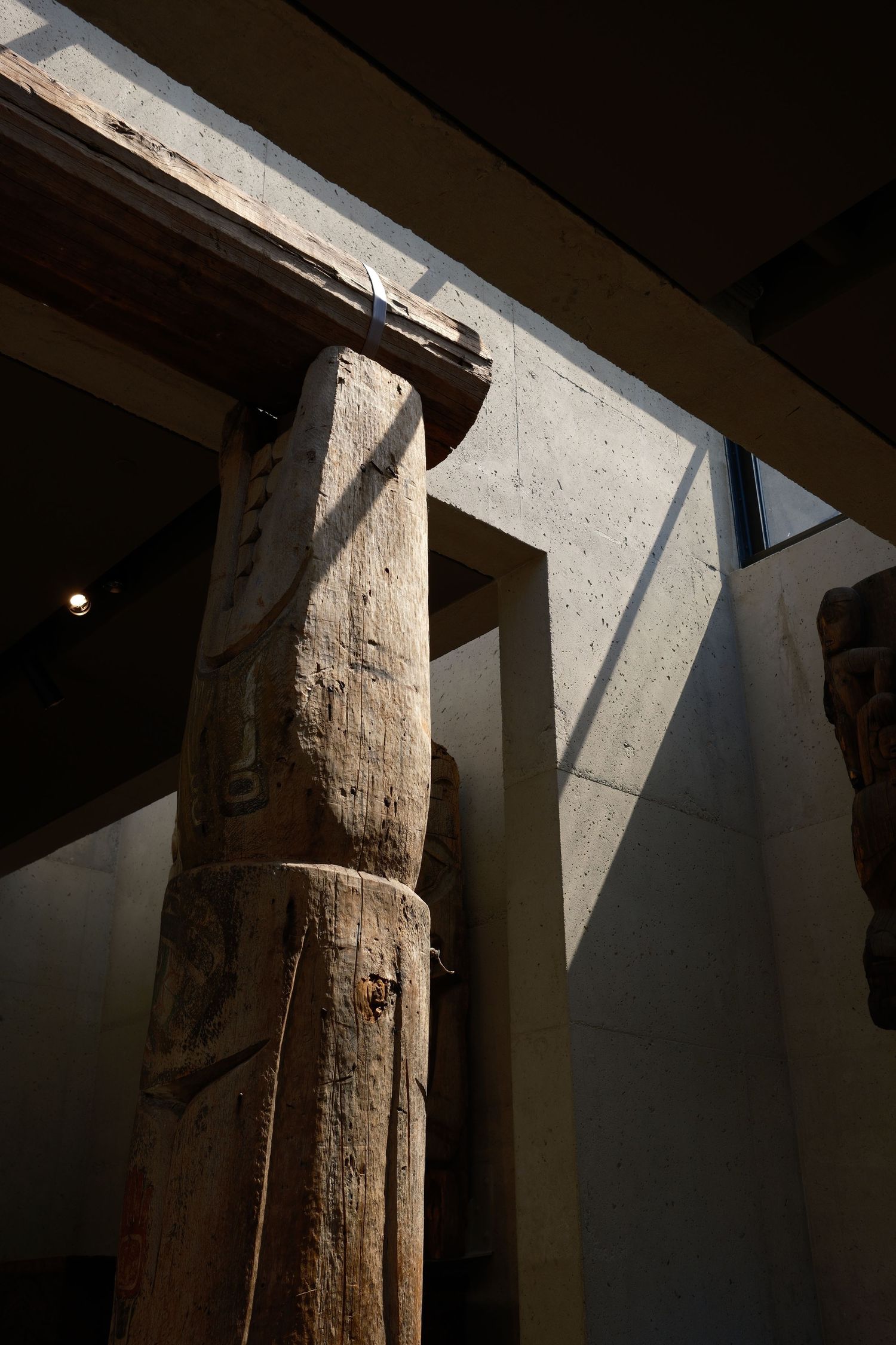 Moody Native American structure with sun streaming through windows, highlighting its edges