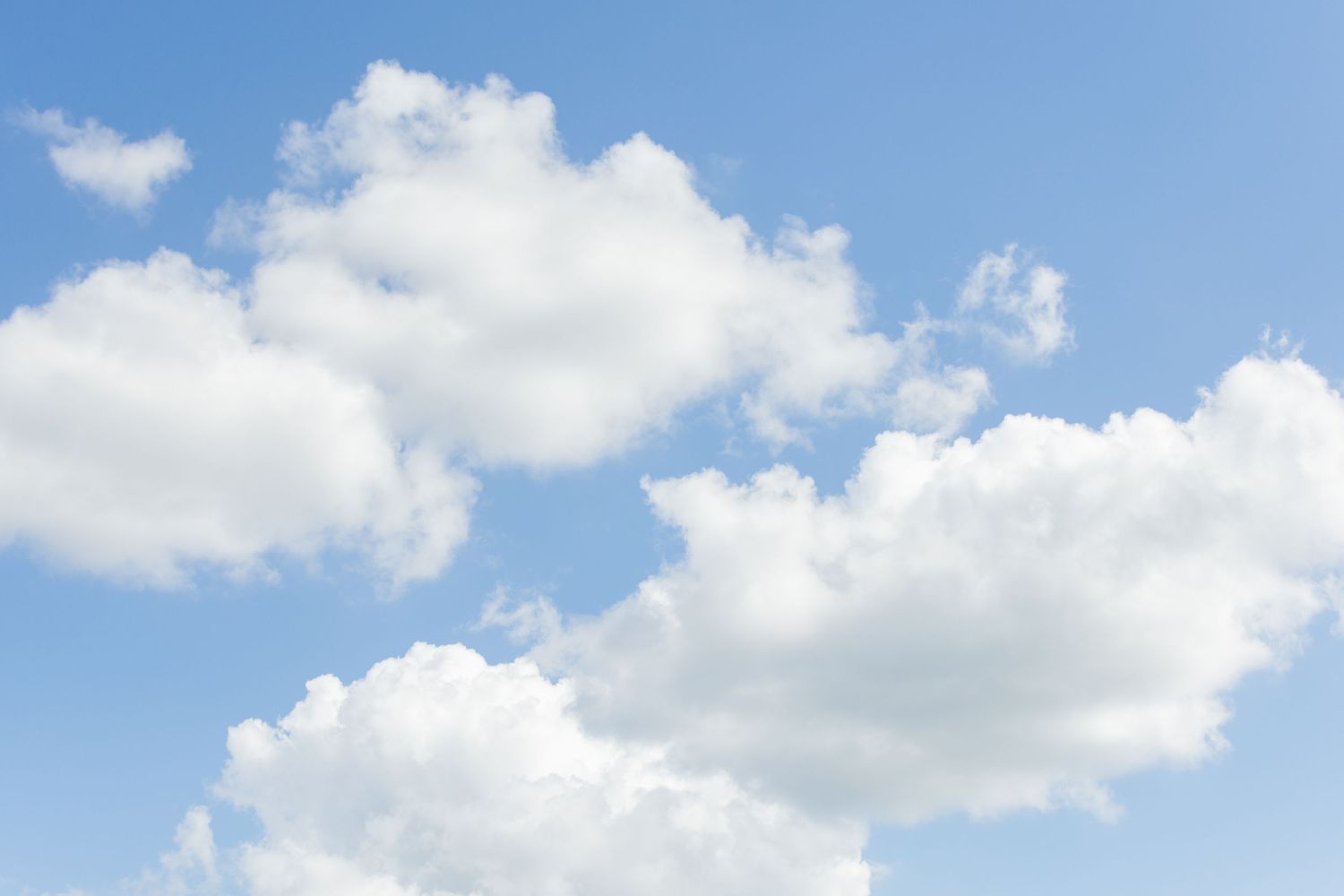 Blue sky with fluffy clouds on a warm summer day in Texas.