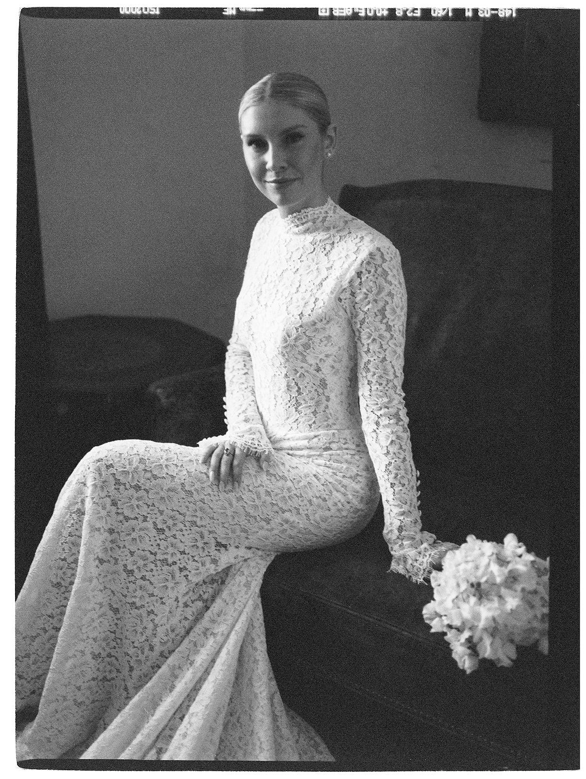 Black and white bridal portraits showcase an elegant long-sleeved lace wedding dress with a flowing skirt.
