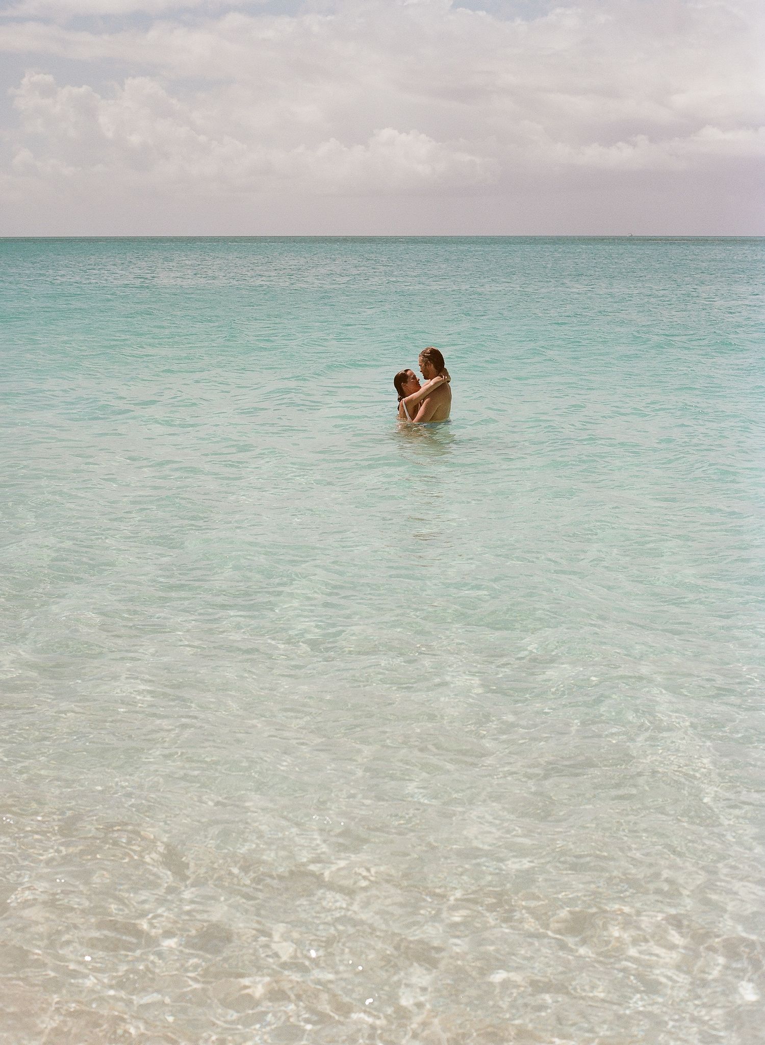 A series of ocean scenes at a tropical beach with crystal clear turquoise waters stretching to the horizon.