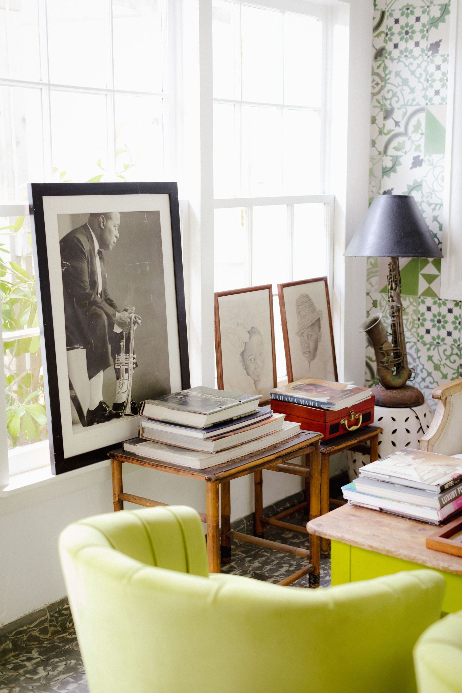 A cozy interior setting with black and white framed artwork alongside a bright lime green accent chair.