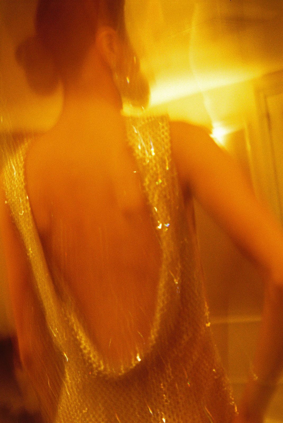 Abstract golden light pattern creates a warm glowing effect with blurred motion streaks and bokeh texture.