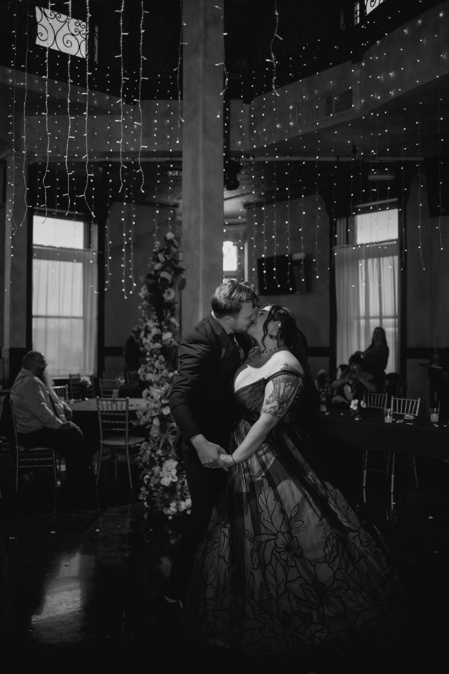 A sequence showing a couple dancing in a dimly lit room with string lights creating a romantic atmosphere.