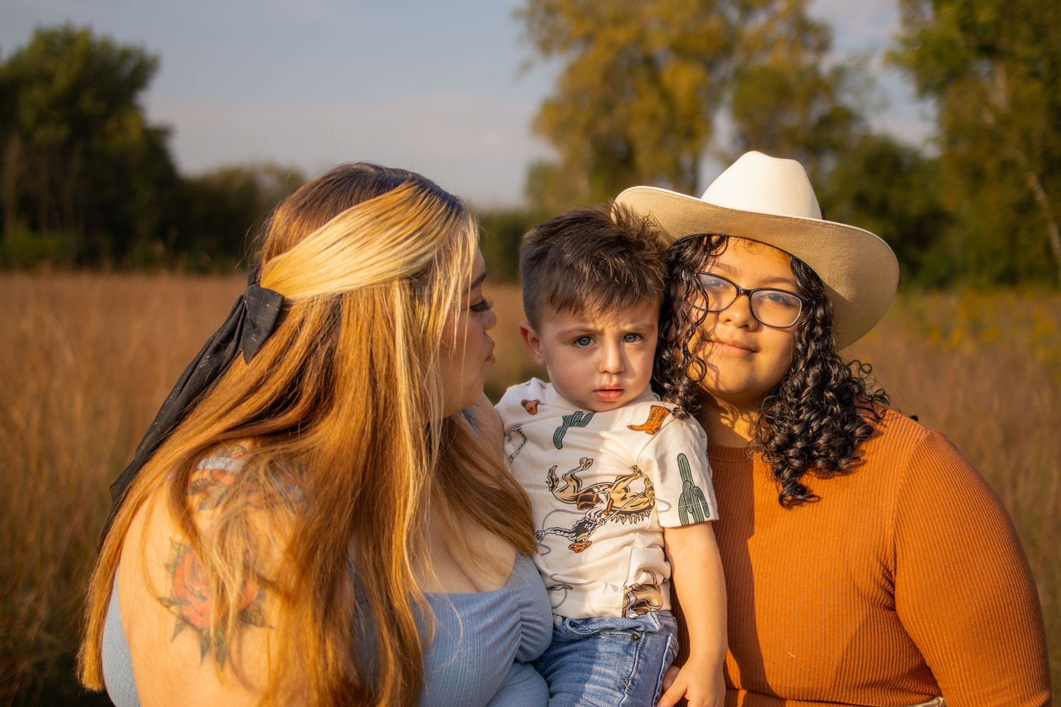 A series of candid outdoor family photos captured during golden hour in a sun-lit field at sunset.