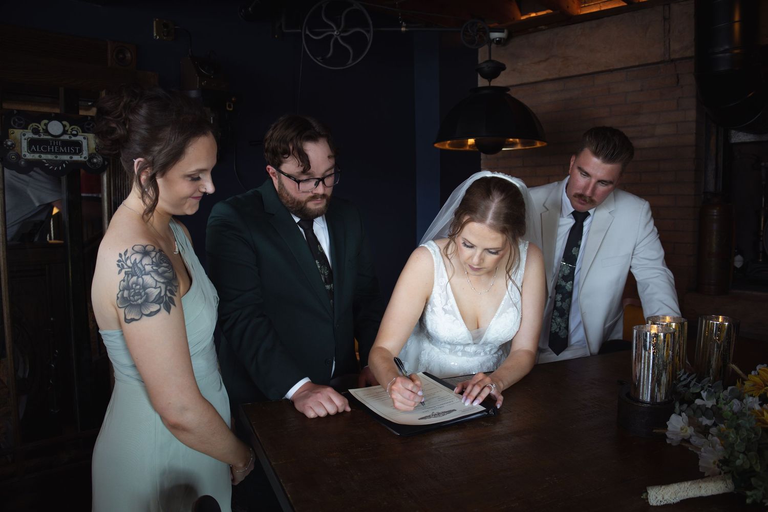 A dimly lit wedding reception showing couples dancing and enjoying an intimate evening celebration.