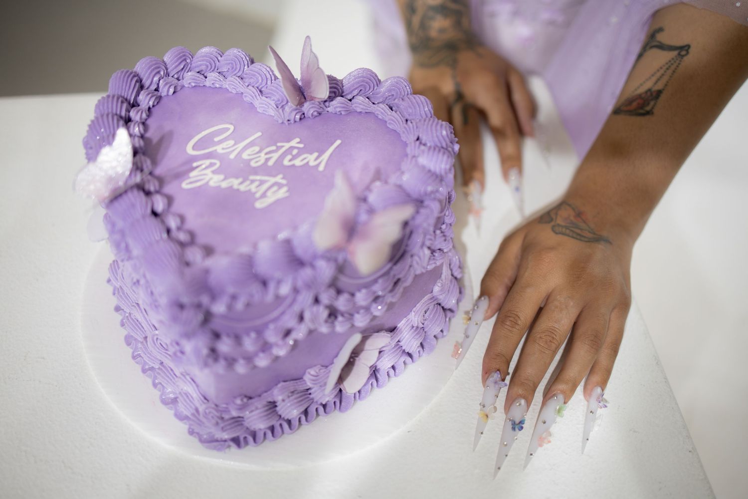 Four detailed photos showing purple ombré heart-shaped cushion being delicately handled, featuring gradient design and plush texture.