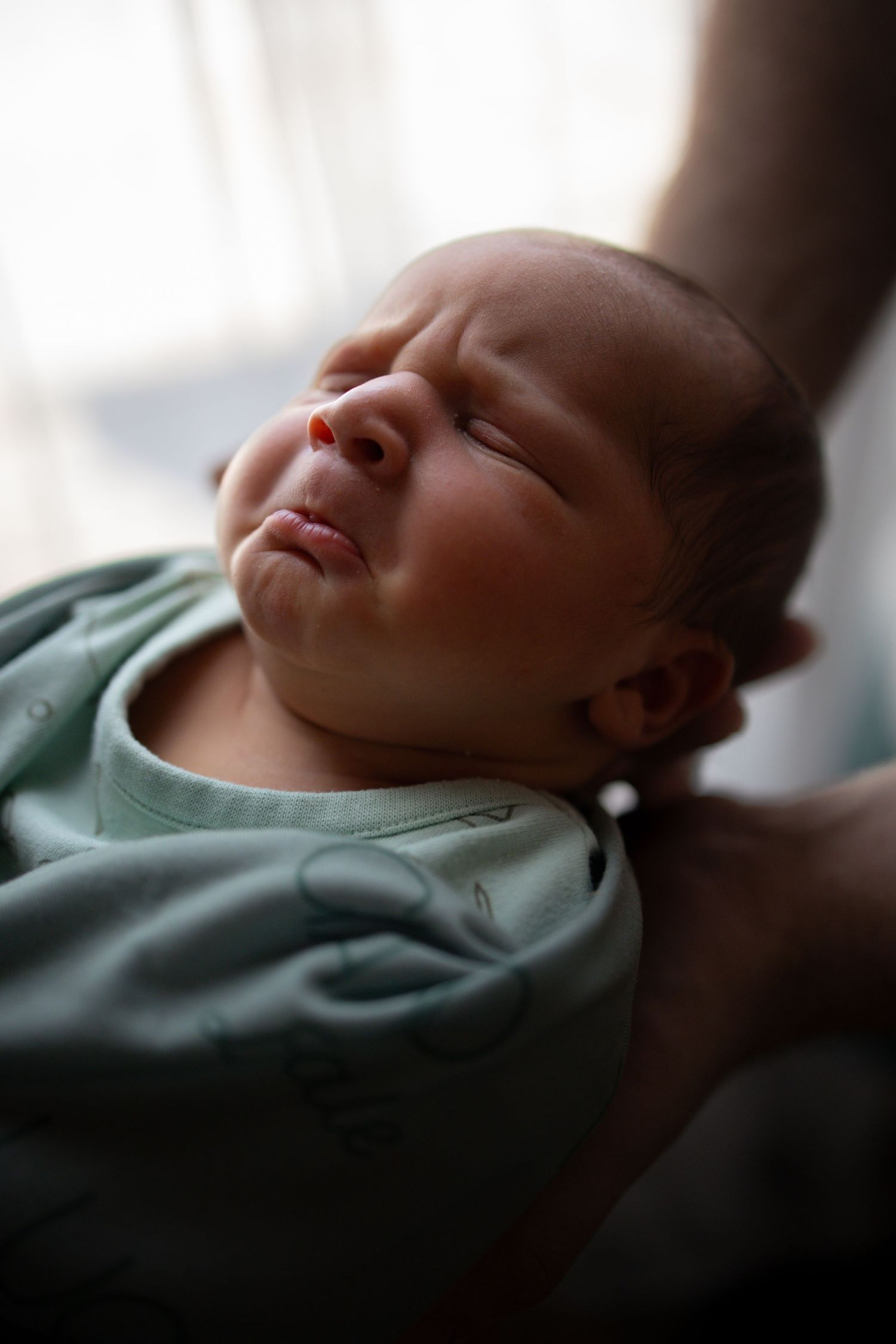 A collage sequence shows a sleeping baby in a green outfit viewed from different angles at peaceful rest.
