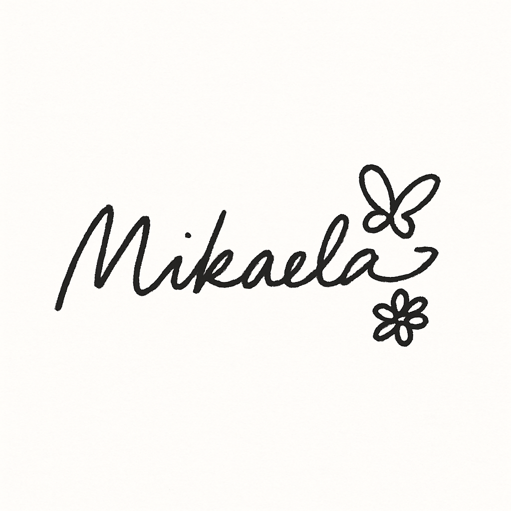 Handwritten text with the name 'Mikaela' written in cursive script with decorative flower doodles.