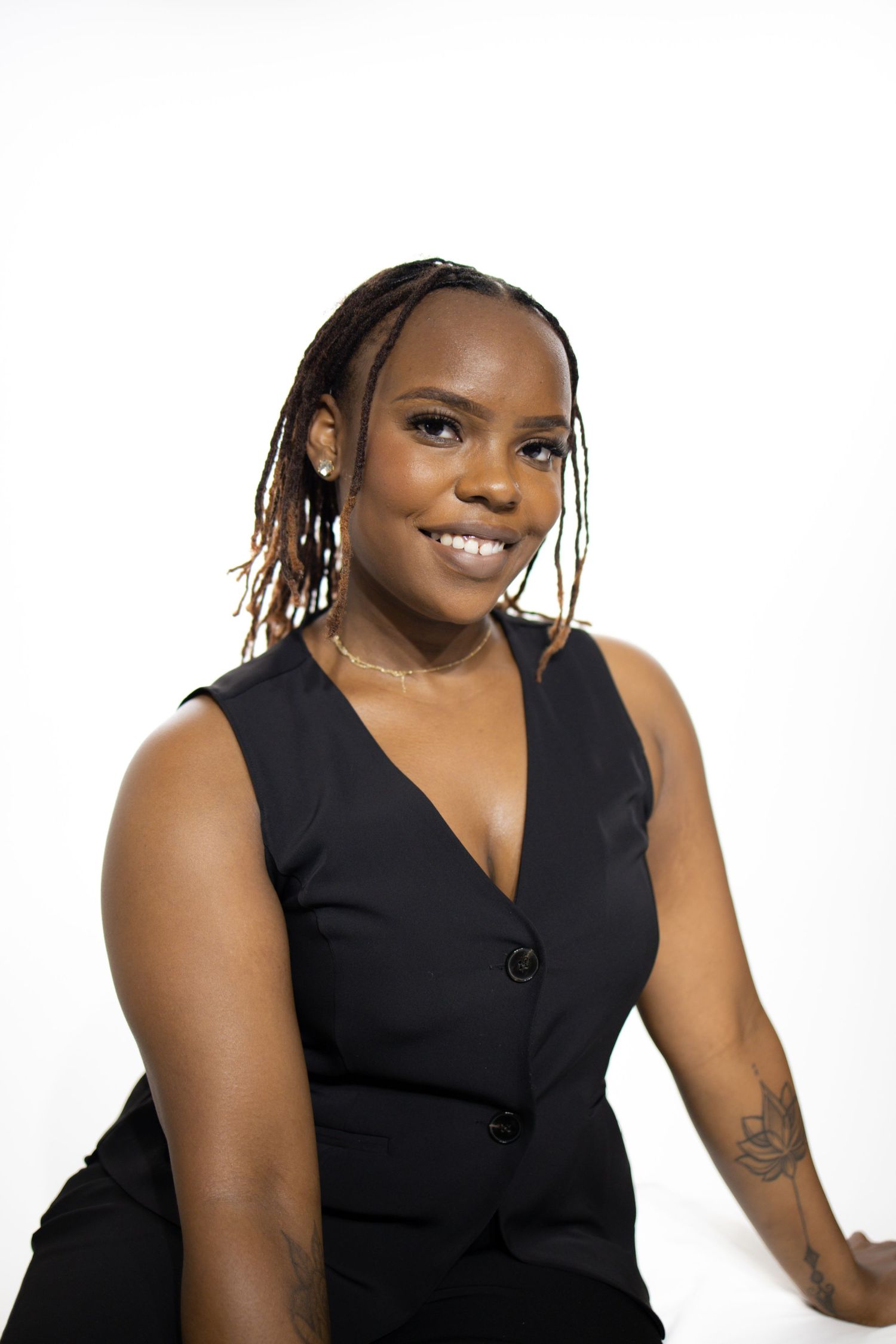 A sequence of professional studio photographs showing different poses in a sleek black sleeveless top.