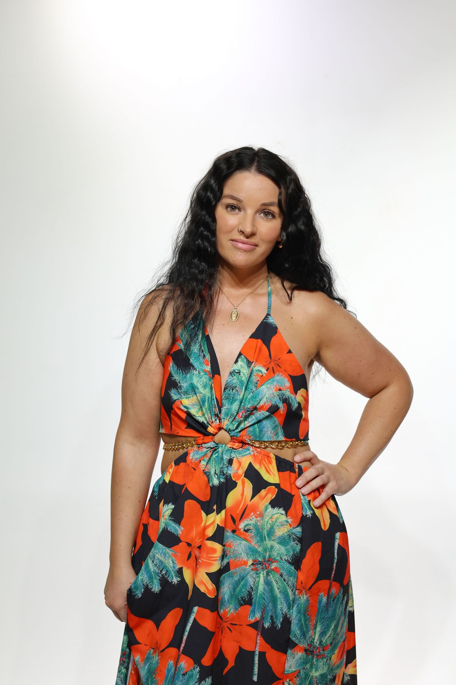 A plus size tropical print maxi dress in vibrant orange and teal floral pattern against a white background.