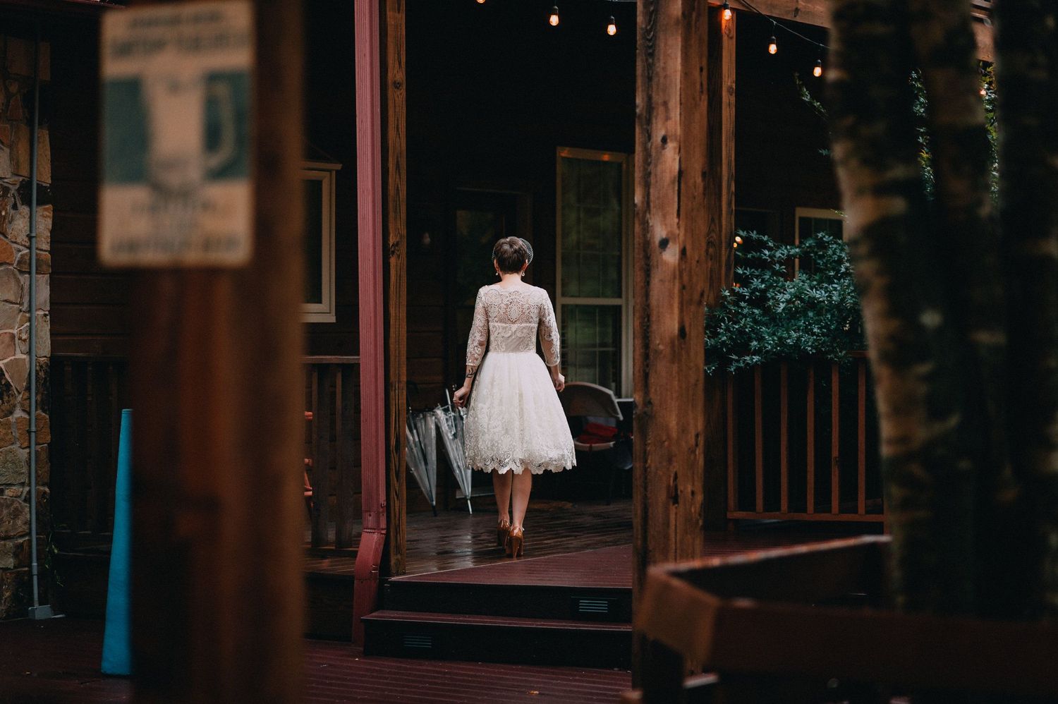 Evening wedding venue with warm lighting and wooden architectural details.