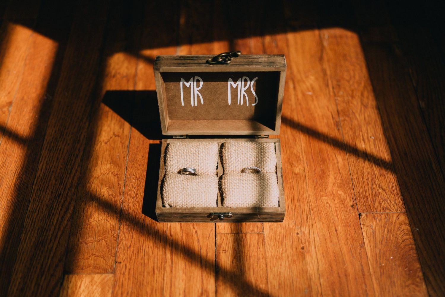Wooden signs with 'Mr & Mrs' text casting dramatic shadows in warm lighting.