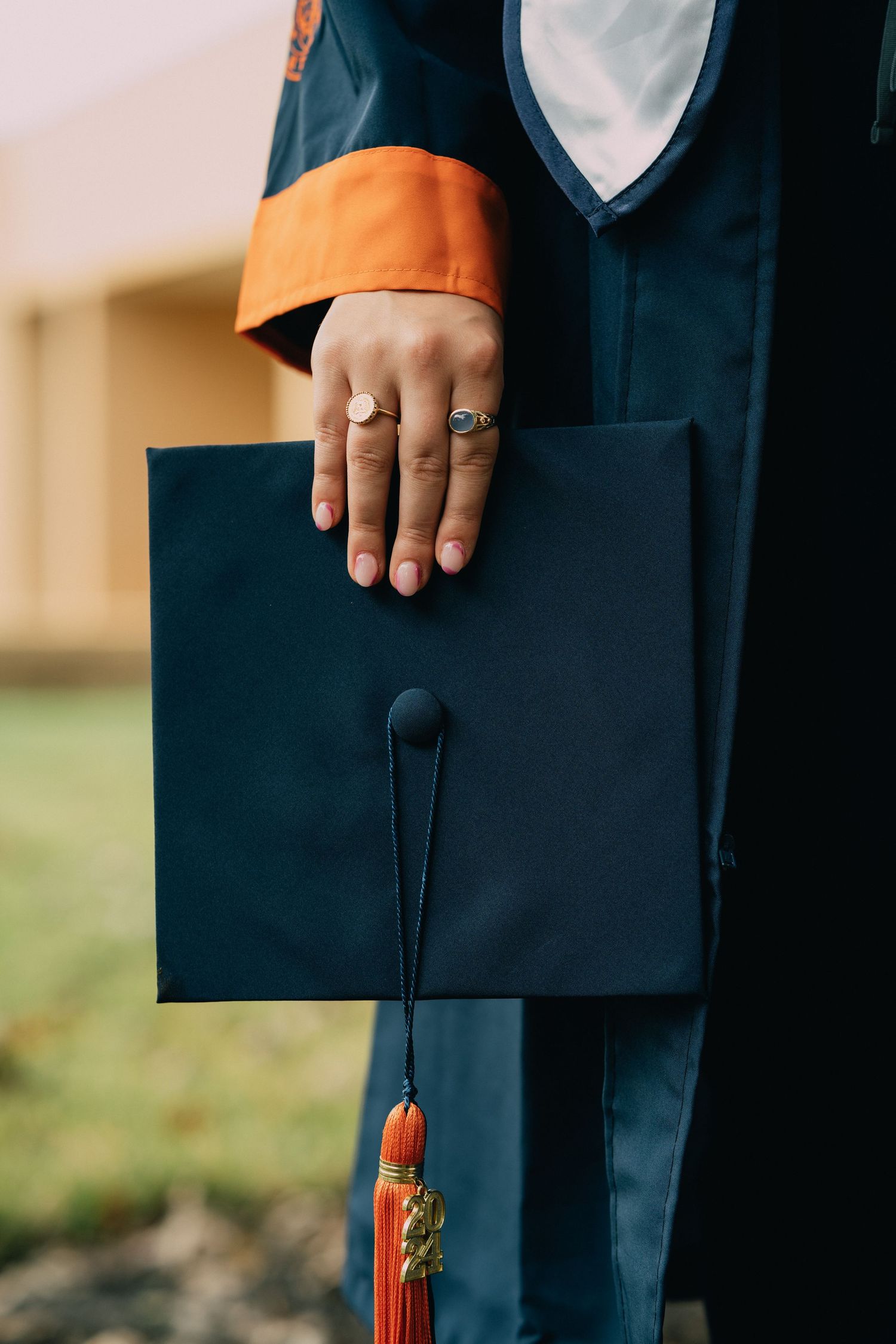 Close-up of graduation cap with tassel and decorative elements.
