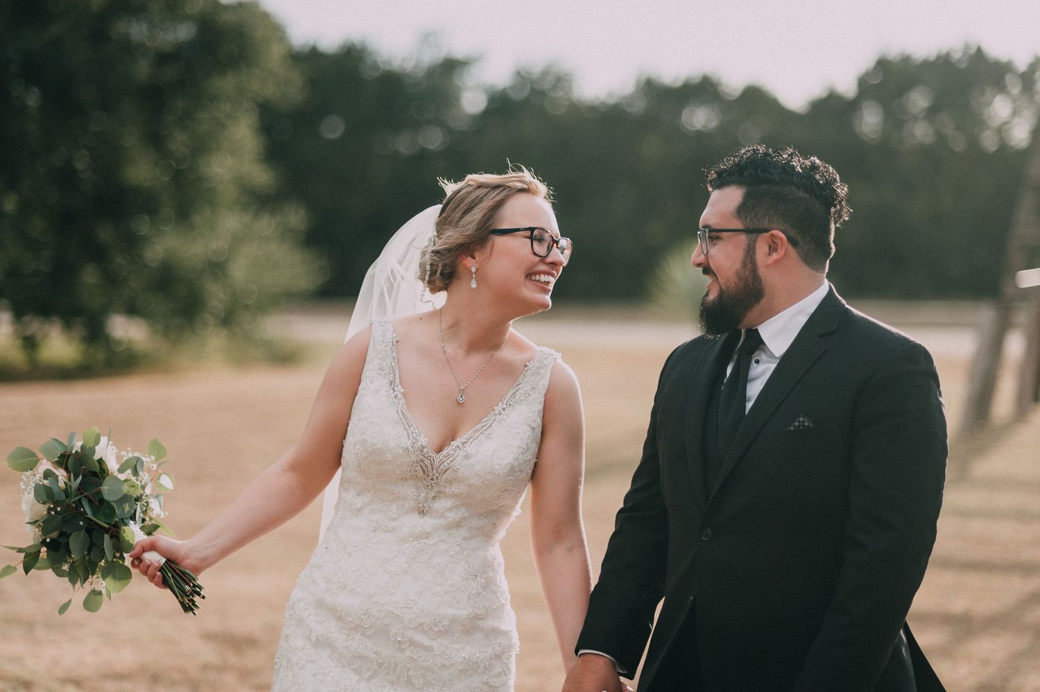 A joyful wedding moment captured in a rustic outdoor setting.