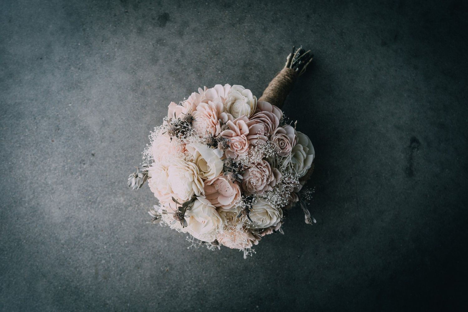 Romantic blush pink and white floral arrangement on dark background.