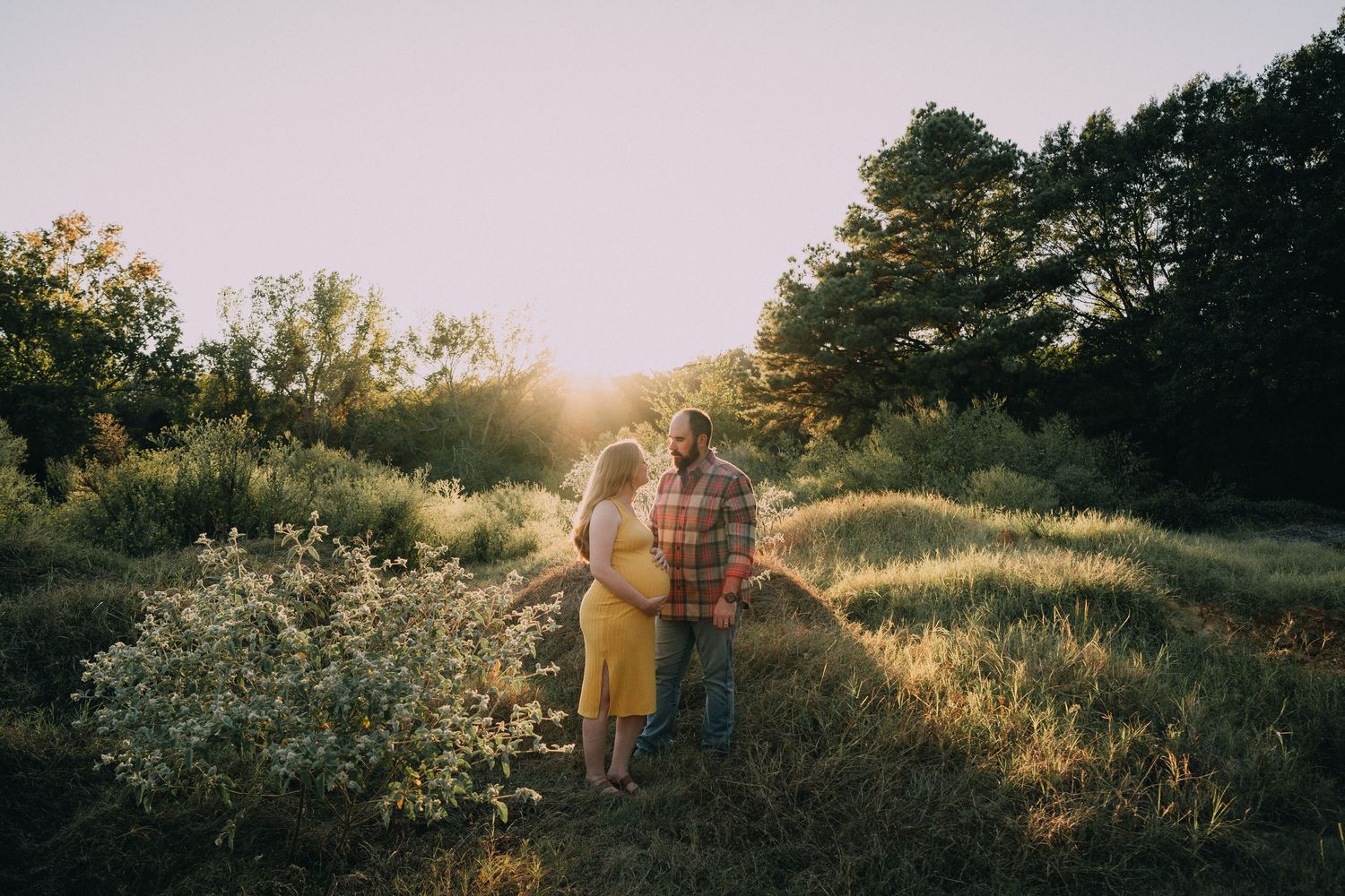 A romantic sunset portrait session in a golden meadow with wildflowers.