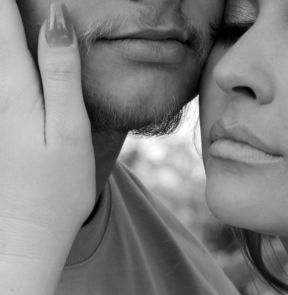 Intimate black and white close-up of a couple's faces touching tenderly.