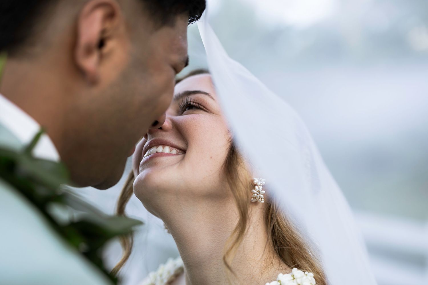 Close up of a romantic wedding couple sharing an intimate moment during their outdoor ceremony.