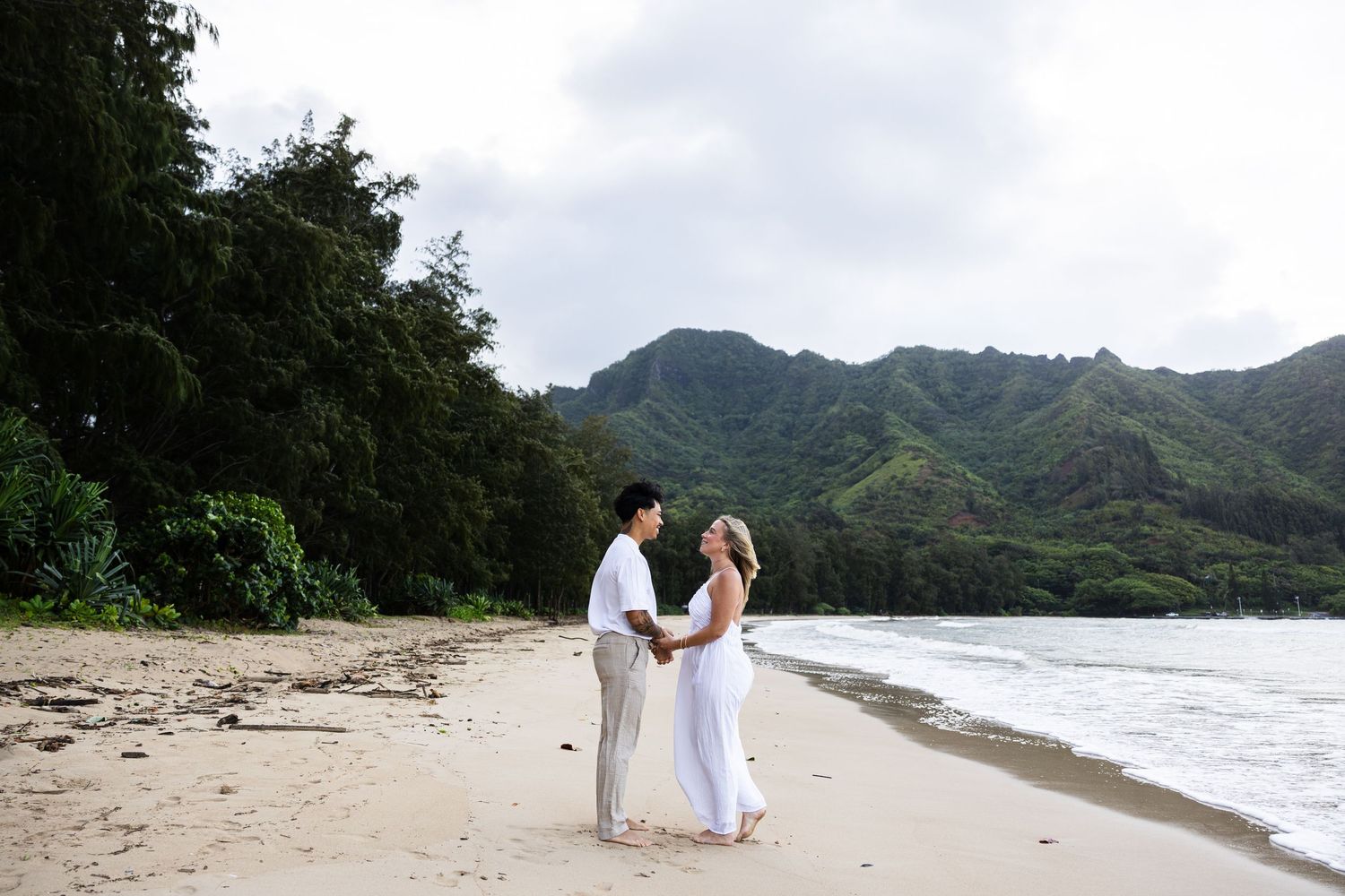 A romantic beach wedding ceremony and celebration captured across multiple scenic shots along a tropical Hawaiian shoreline.
