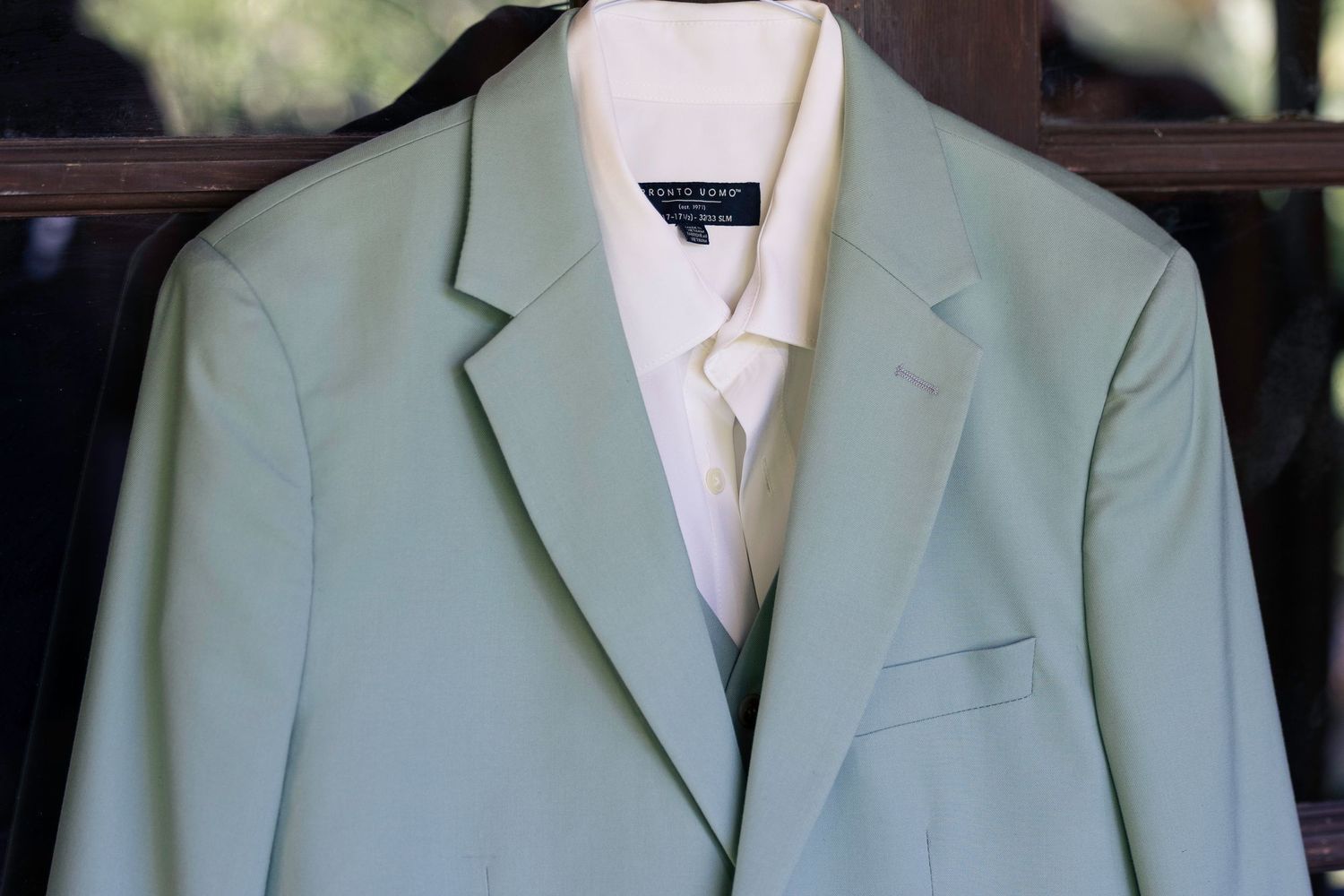 A light mint green blazer jacket shown from multiple angles displaying its tailored construction and classic design details.