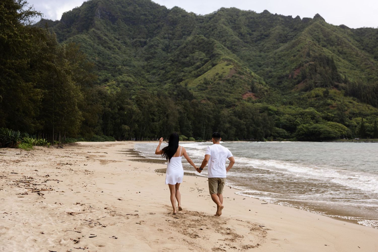 A scenic sequence of beach and mountain views in Hawaii showing lush green peaks and sandy coastline.