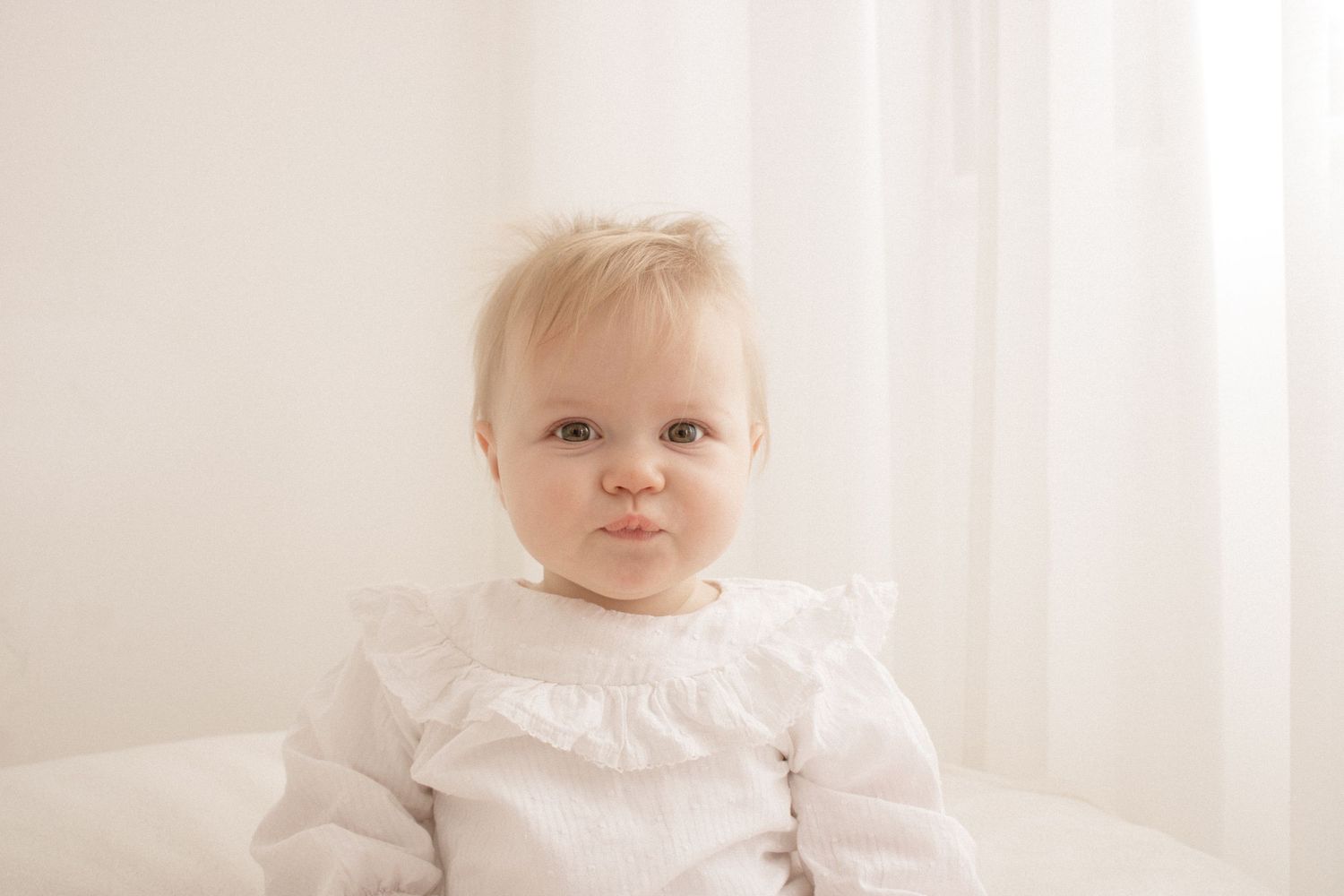 A tender moment between parent and child against a bright white backdrop.