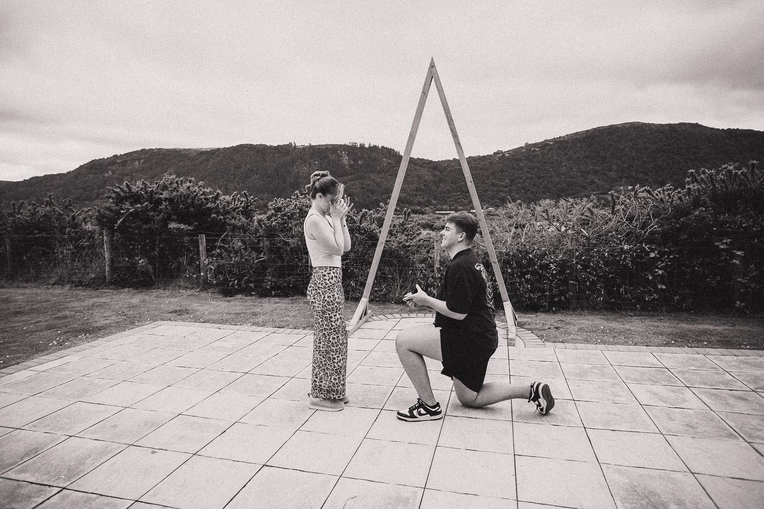 Outdoor photoshoot sequence showing a person swinging in a park setting with mountains in the background.