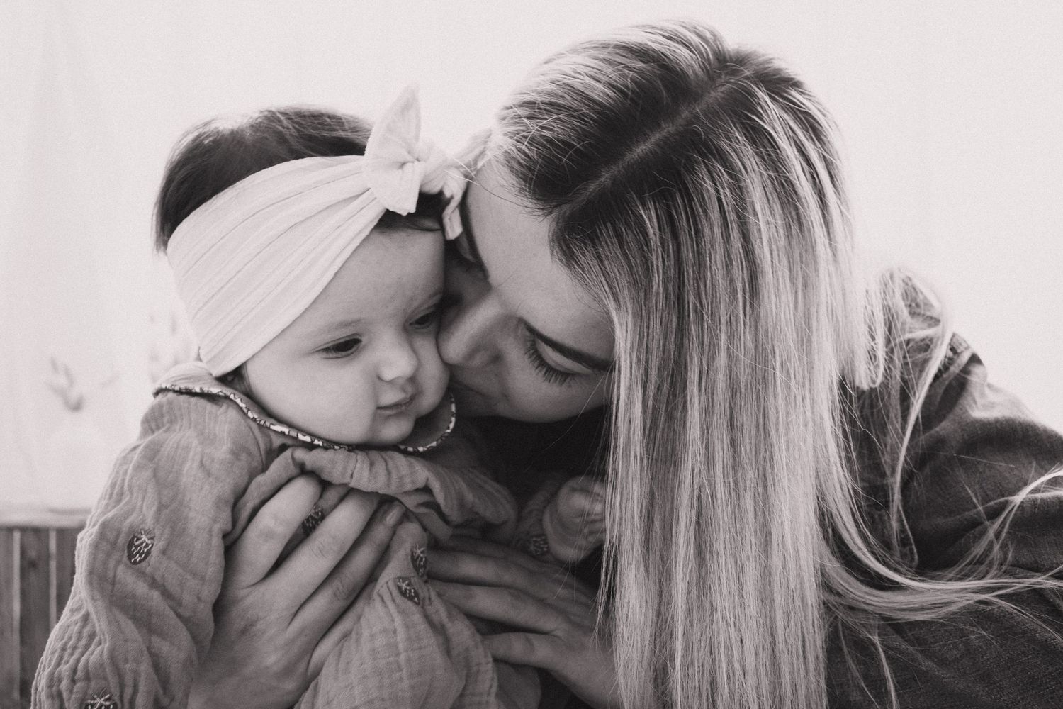 A collection of black and white photographs showing tender moments between a parent and child.