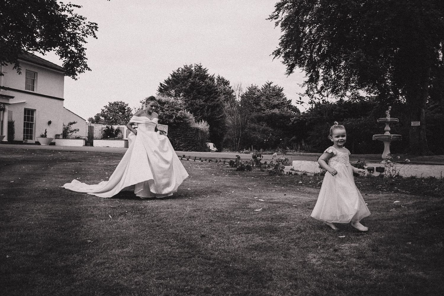 Black and white sequence of romantic wedding photos taken outdoors on a grassy field.