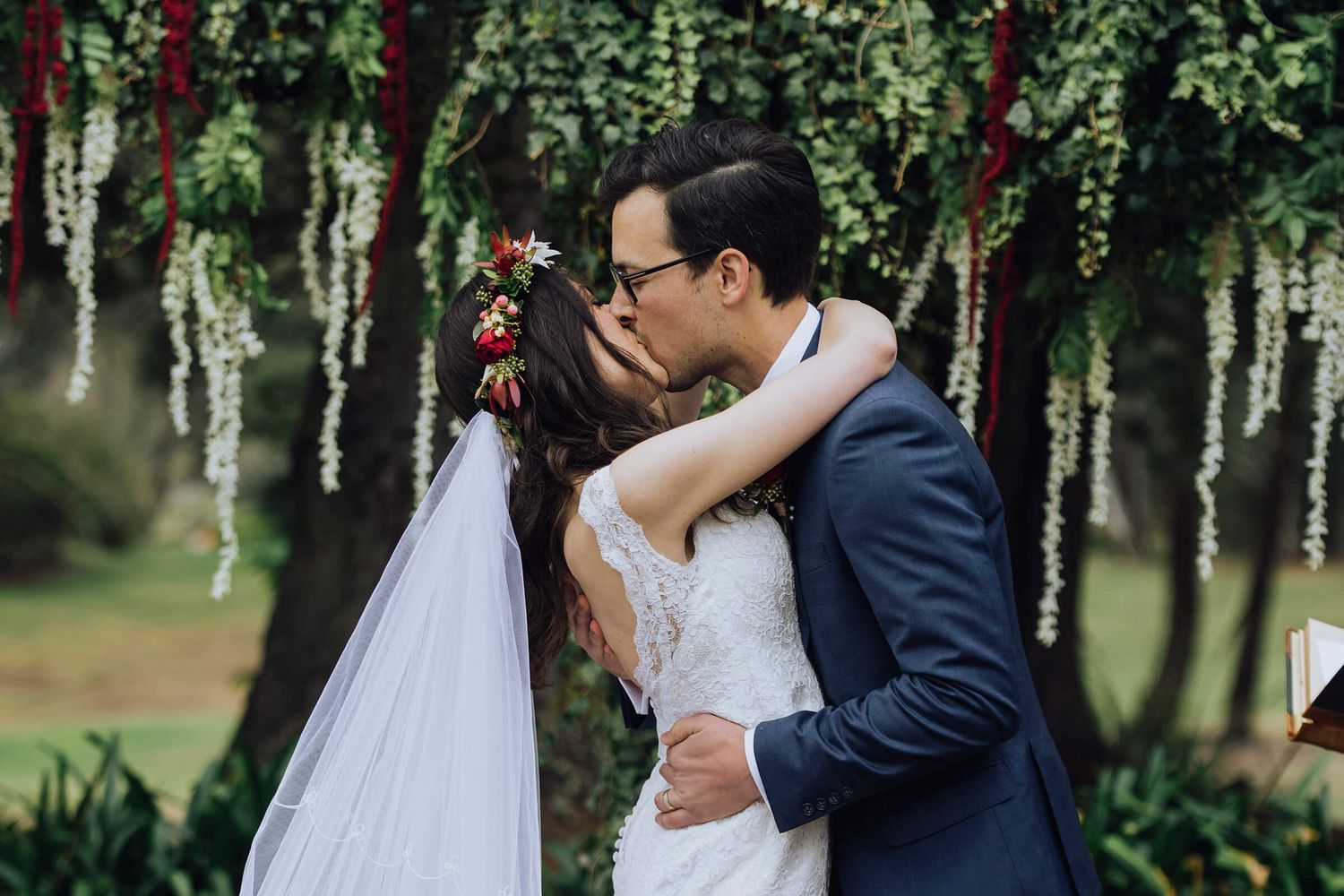 Bride and groom sharing first kiss during ceremony in Southern Highlands - Zara King Photography, Sydney Australia