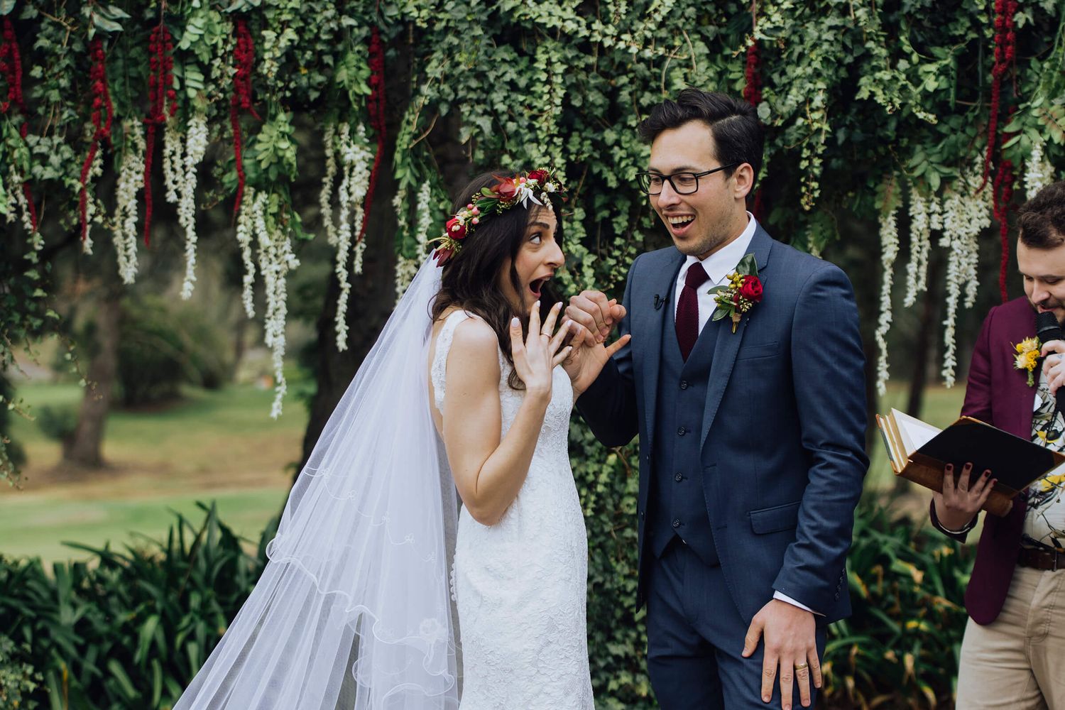 Bride and groom looking at each other with mouths wide open in excitement during ceremony - Zara King Photography, Sydney Australia