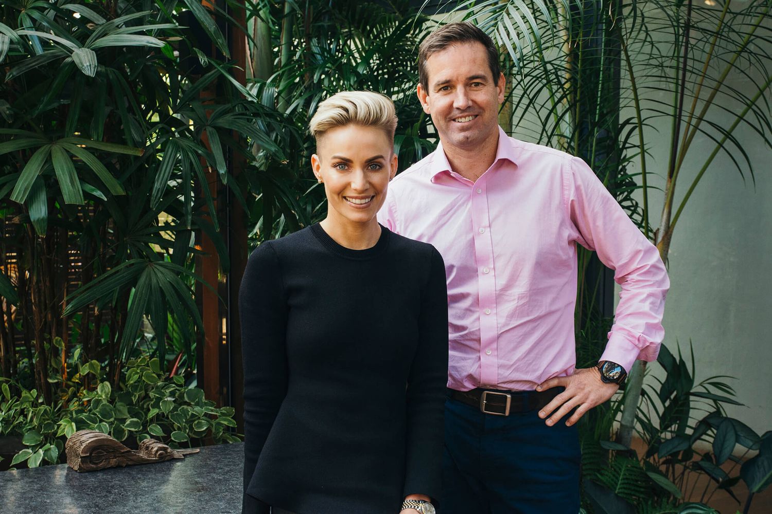 Man standing behind seated woman during corporate headshot session outdoors in Paddington - Zara King Photography, Sydney Australia
