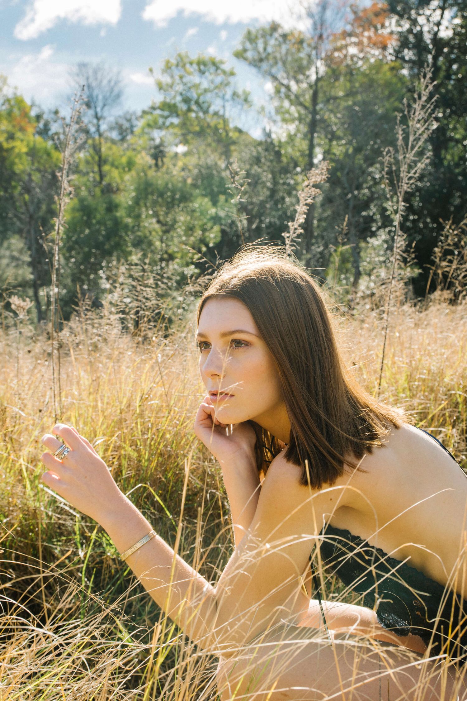 Girl in lingerie sitting in overgrown grass during modelling photo shoot in Blue Mountains - Zara King Photography, Sydney Australia