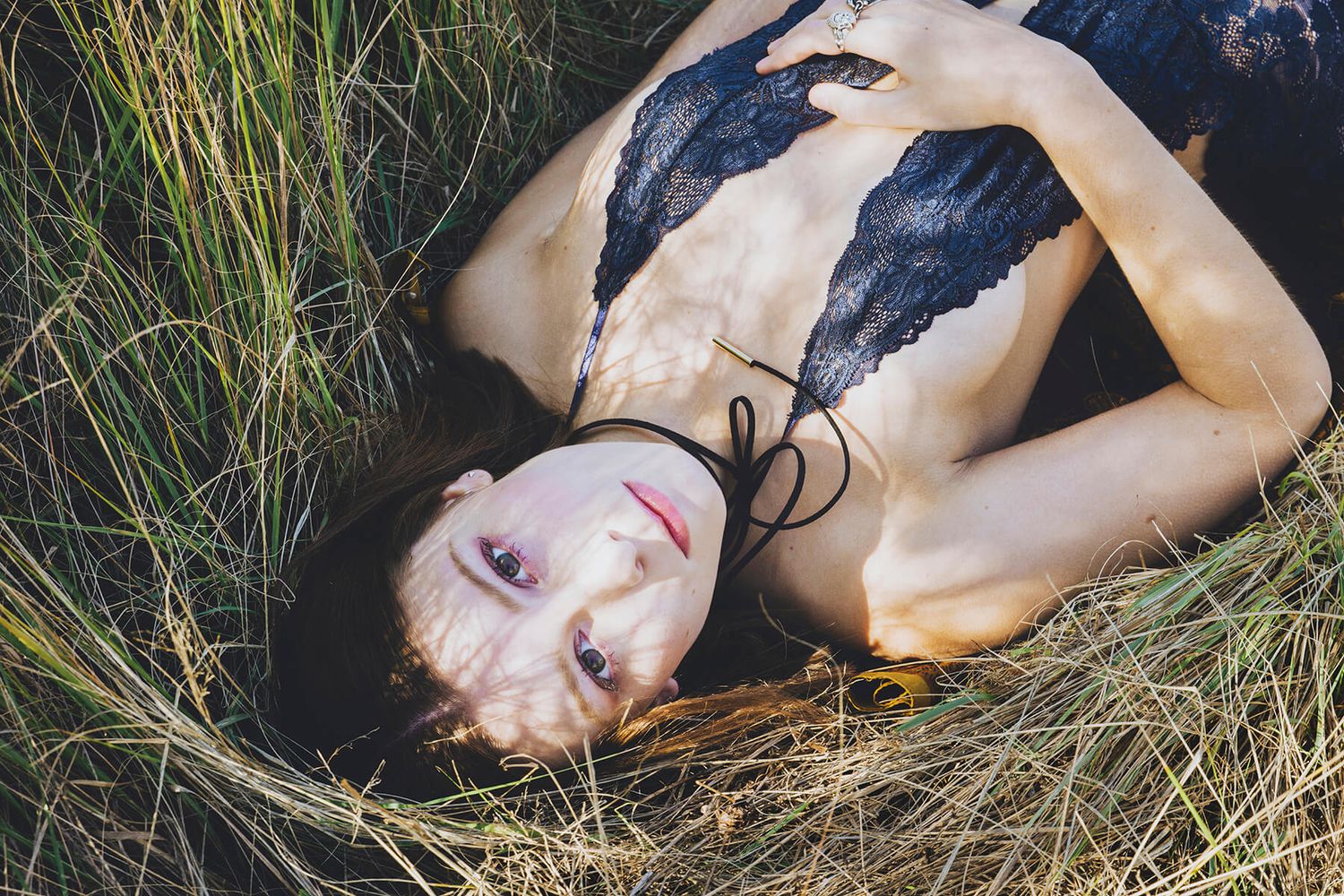 Girl in lingerie lying in overgrown grass during modelling photo shoot in Blue Mountains - Zara King Photography, Sydney Australia