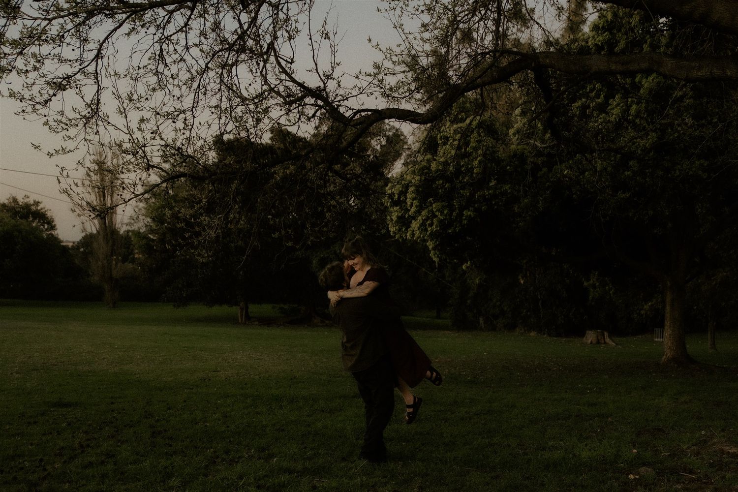 Zara King and fiancé hugging while he swings her around