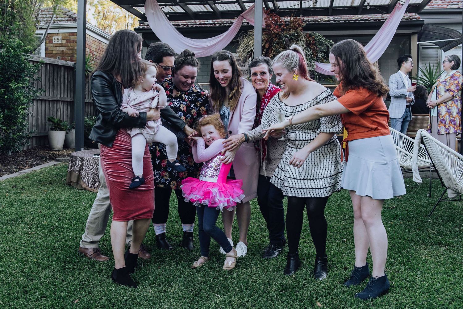 Little girl being tickled by all her aunts during in-home birthday party session - Zara King Photography, Sydney Australia