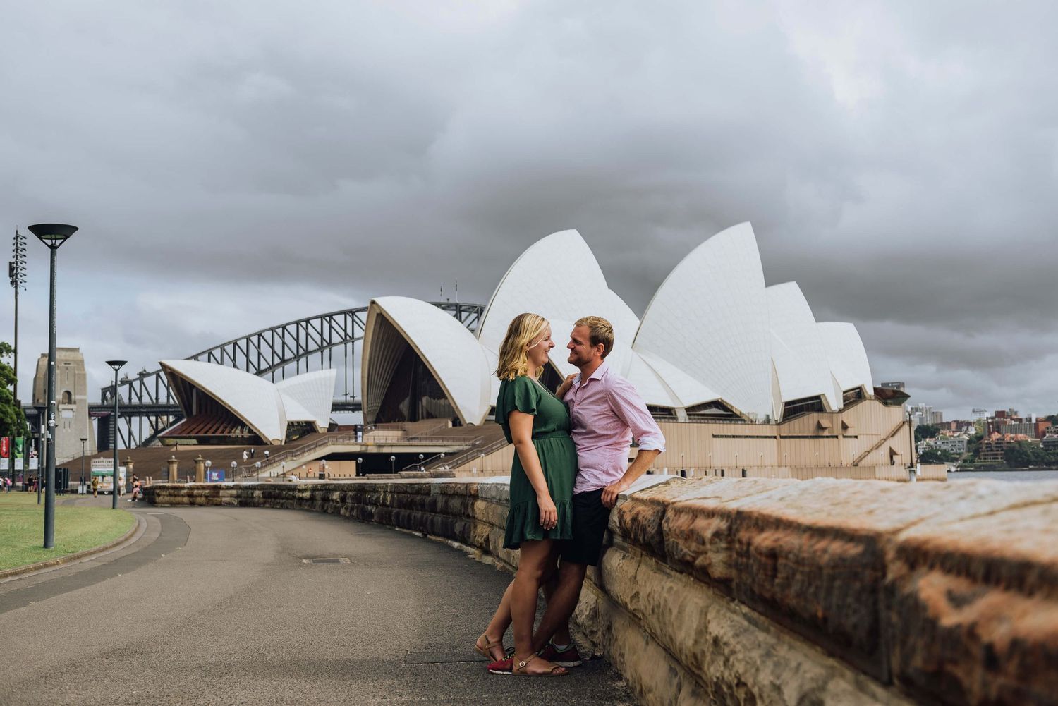Couple cuddling in front of Opera House and Sydney Harbour Bridge - Zara King Photography, Sydney Australia