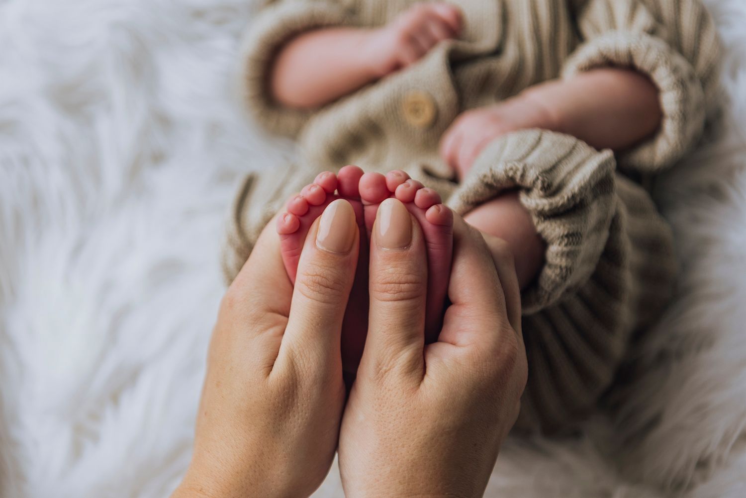Mum's thumbs showing how small her newborn baby's feet are - Zara King Photography, Sydney Australia