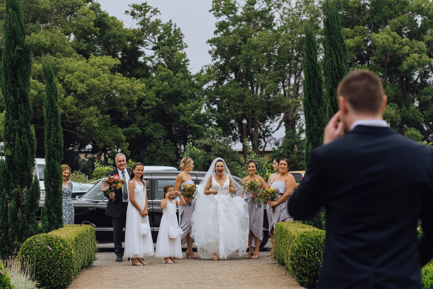 Bride and bridesmaids are excited to see bride's brother at ceremony in Nowra - Zara King Photography, Sydney Australia
