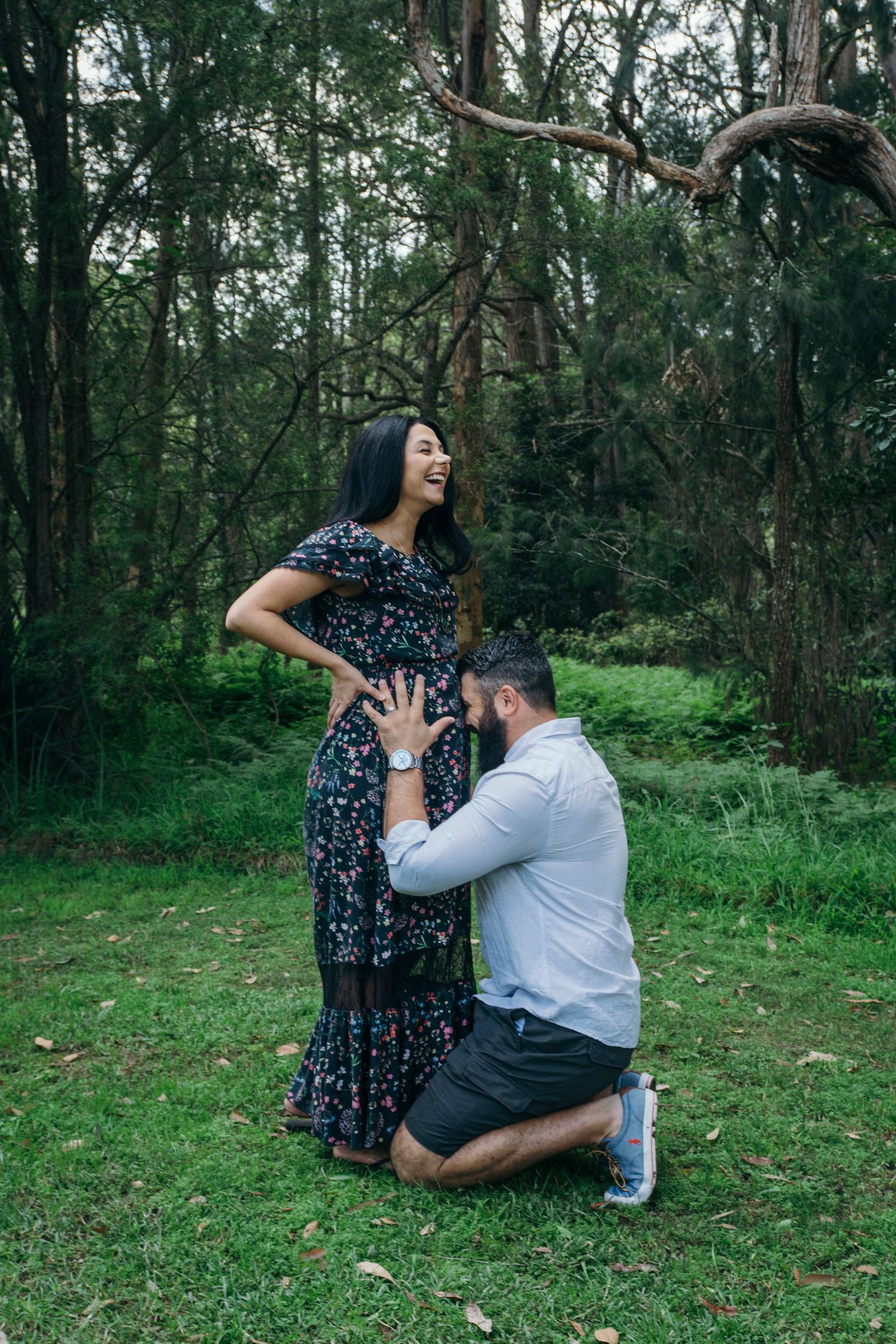 Dad on knees with head on pregnant wife's belly during outdoor family session - Zara King Photography, Sydney Australia