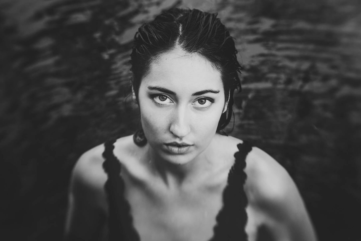 Girl just stepped up out of the water looking up at camera during modelling photo shoot - Zara King Photography, Sydney Australia