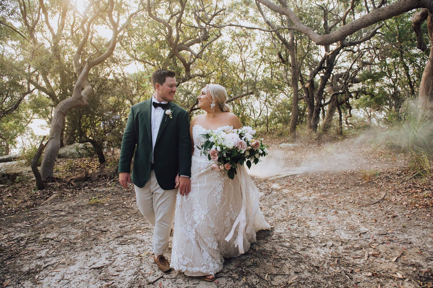 Bride and groom looking at each other while walking in Palm Beach - Zara King Photography, Sydney Australia
