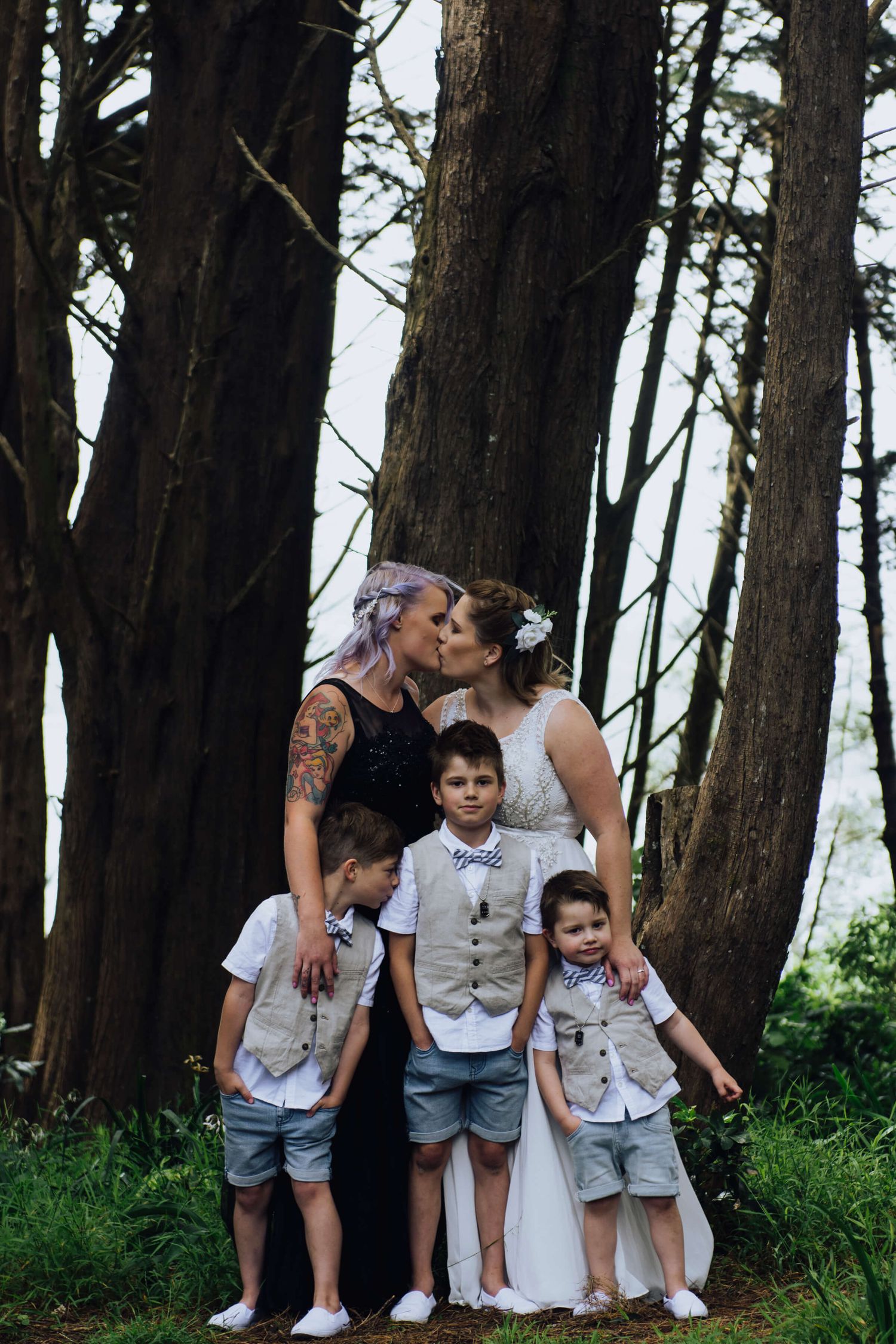 Two brides kissing holding hugging their three sons in Wellington, NZ - Zara King Photography