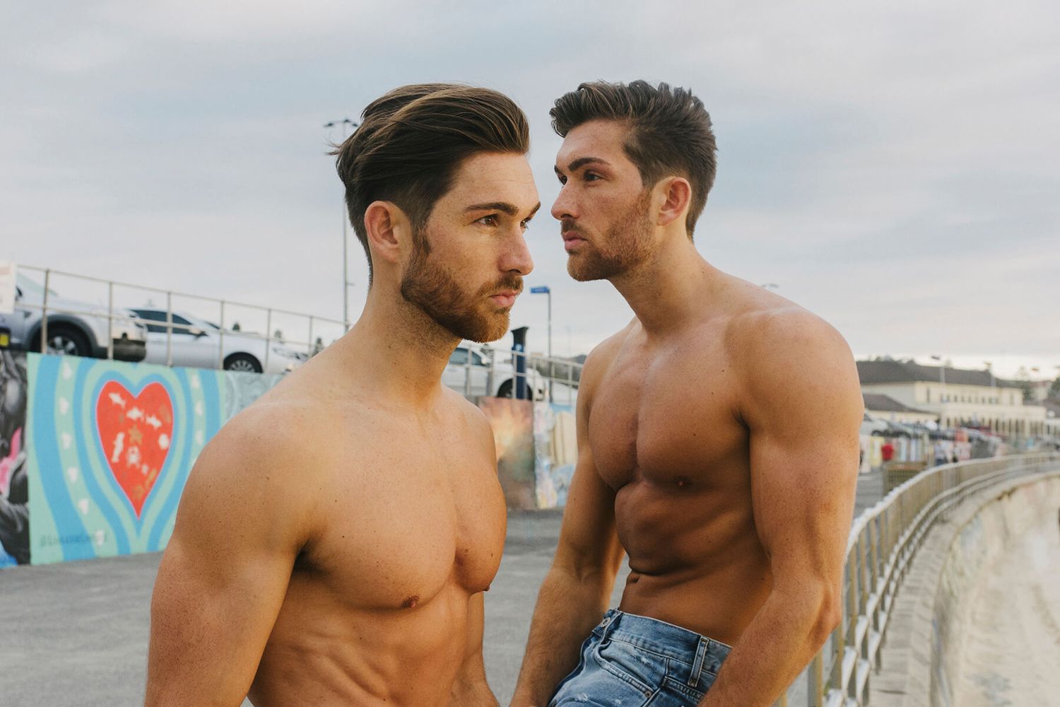 Twin men facing opposite directions during sunrise modelling photo shoot at Bondi Beach - Zara King Photography, Sydney Australia