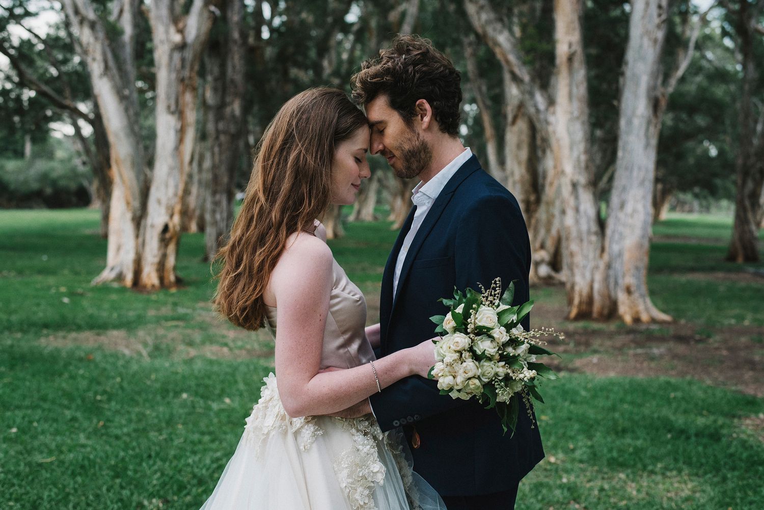 Bride and groom cuddling touching foreheads in Centennial Park - Zara King Photography, Sydney Australia