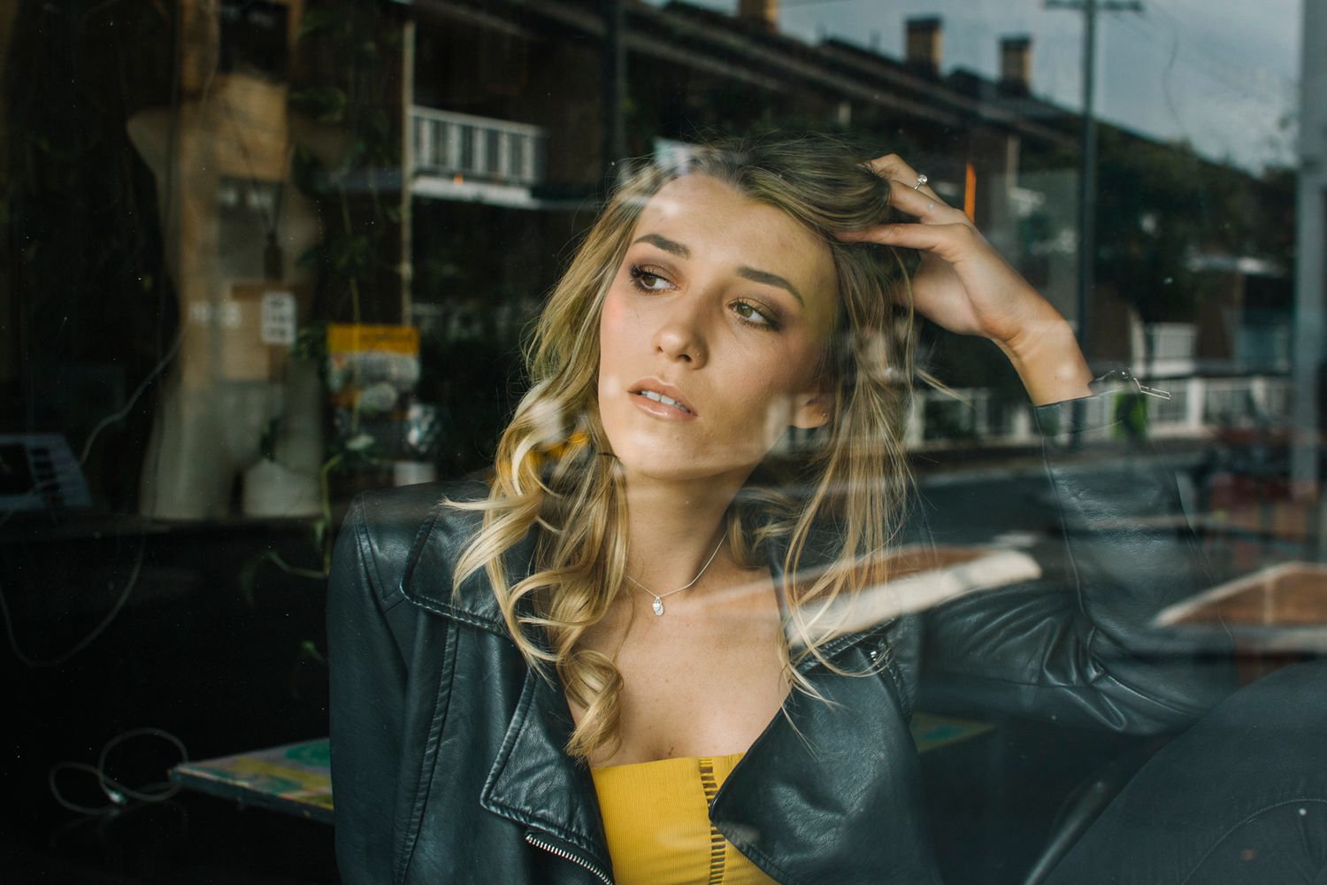 Model sitting in window at cafe during location photo shoot in Newtown - Zara King Photography, Sydney Australia