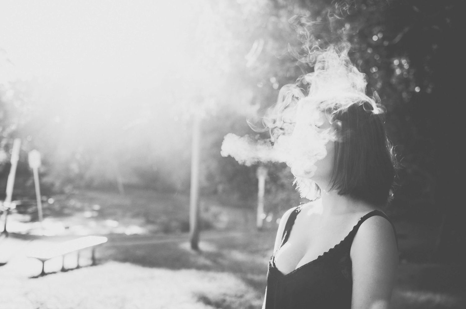 Girl blowing out smoke and obscuring her face during modelling photo shoot in Lane Cove - Zara King Photography, Sydney Australia